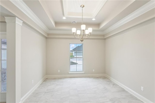 spare room featuring a notable chandelier, ornamental molding, and a raised ceiling