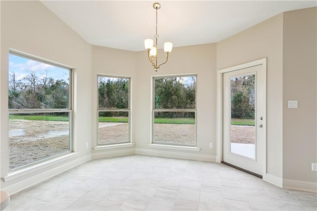 unfurnished dining area with a wealth of natural light and a chandelier