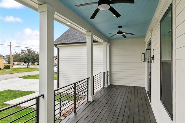 wooden terrace featuring ceiling fan and a porch