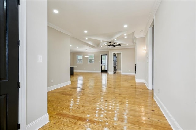 unfurnished living room featuring beamed ceiling, light wood-type flooring, ceiling fan, ornamental molding, and coffered ceiling