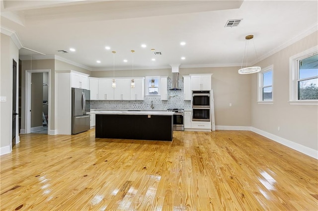 kitchen featuring a kitchen island, decorative light fixtures, white cabinets, and appliances with stainless steel finishes