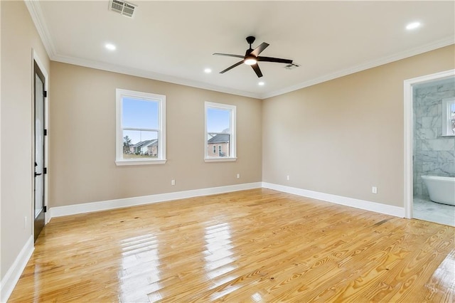 spare room with ceiling fan, crown molding, and light hardwood / wood-style flooring