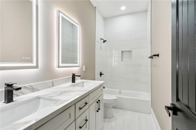 full bathroom featuring tile patterned flooring, tiled shower / bath combo, vanity, and toilet