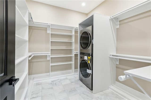 laundry area featuring stacked washer and clothes dryer