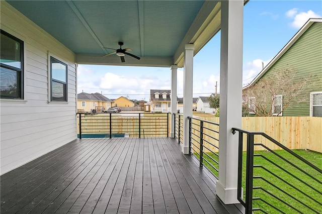 wooden deck featuring ceiling fan and a yard