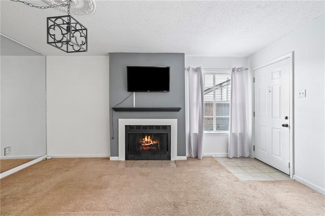 unfurnished living room with light colored carpet, a textured ceiling, and an inviting chandelier