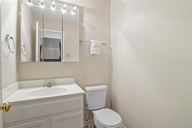 bathroom with toilet and vanity