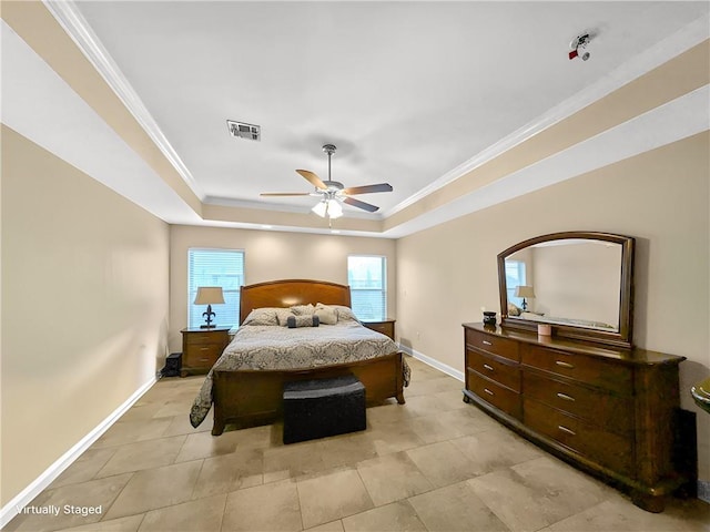 bedroom with ceiling fan, crown molding, and a tray ceiling