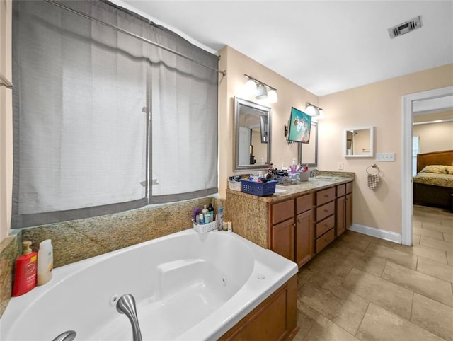 bathroom with a tub to relax in and vanity