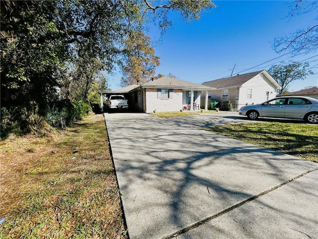 view of front of house with a front yard and a carport