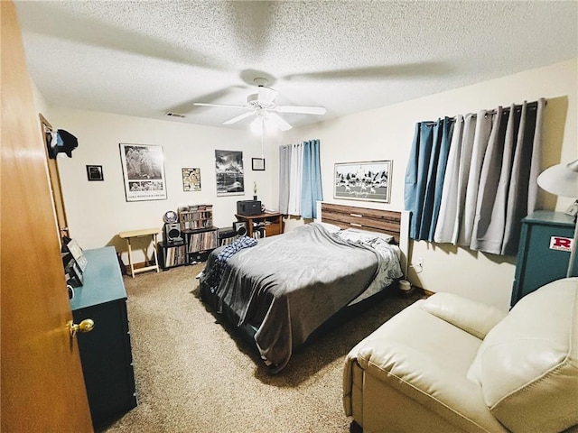 carpeted bedroom with a textured ceiling and ceiling fan