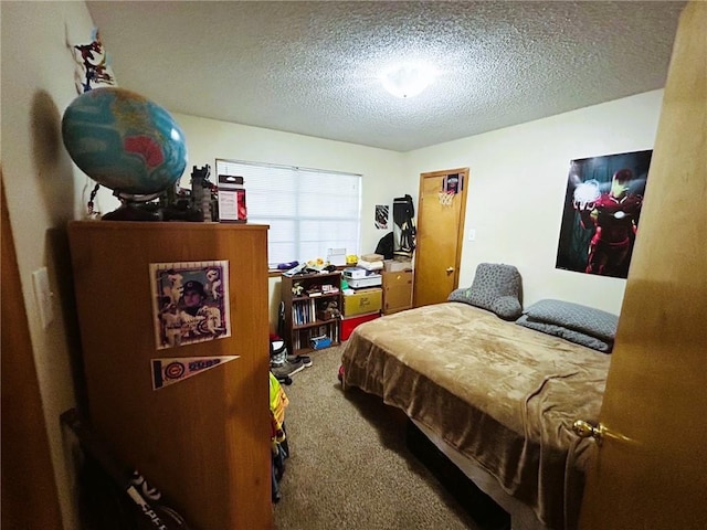 bedroom featuring a textured ceiling and carpet