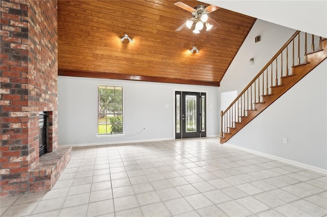 unfurnished living room featuring ceiling fan, wood ceiling, a fireplace, and light tile patterned floors