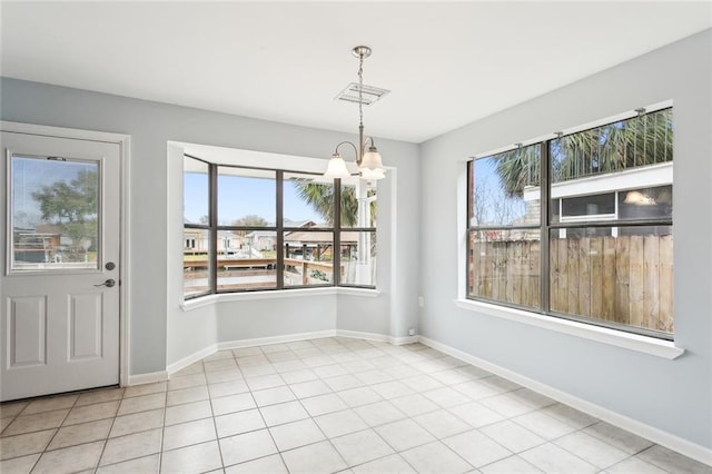 unfurnished dining area featuring a notable chandelier and light tile patterned floors