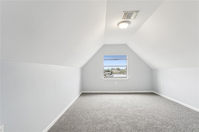 bonus room with carpet floors and vaulted ceiling