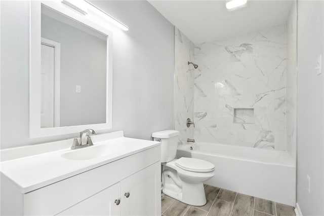 full bathroom featuring toilet, tiled shower / bath combo, and vanity