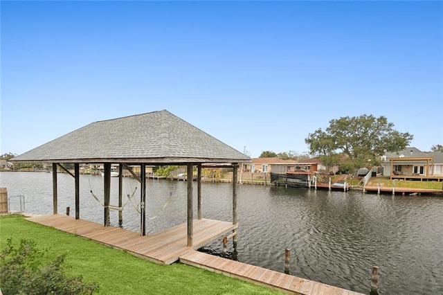 dock area featuring a lawn and a water view