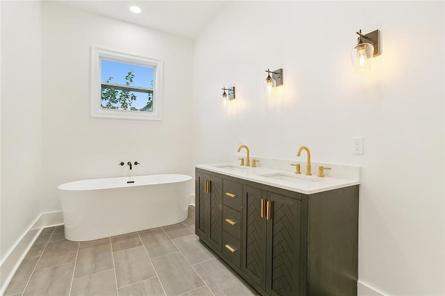 bathroom featuring tile patterned flooring, a tub to relax in, and vanity