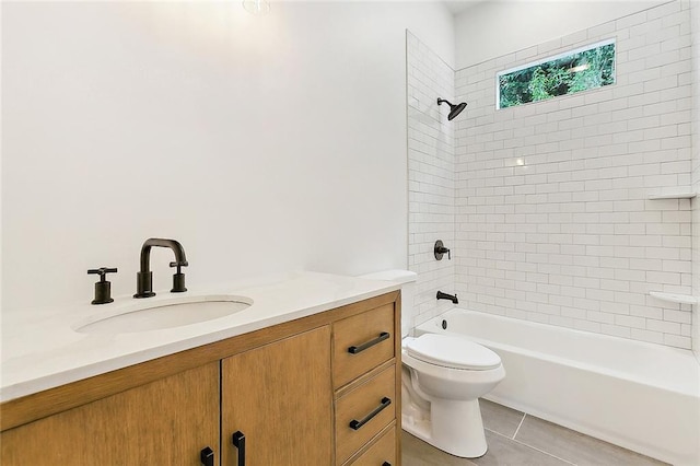 full bathroom with tile patterned flooring, toilet, vanity, and tiled shower / bath