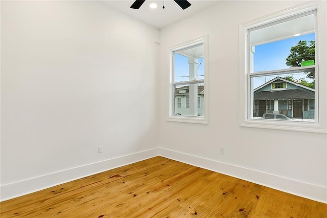 empty room with ceiling fan and hardwood / wood-style floors