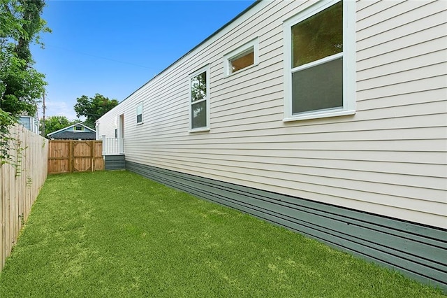 view of side of home featuring a lawn