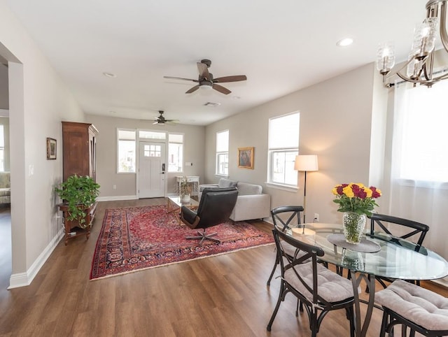 living room featuring ceiling fan, a wealth of natural light, and dark hardwood / wood-style flooring