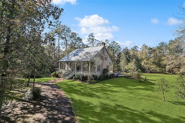 exterior space with covered porch and a lawn