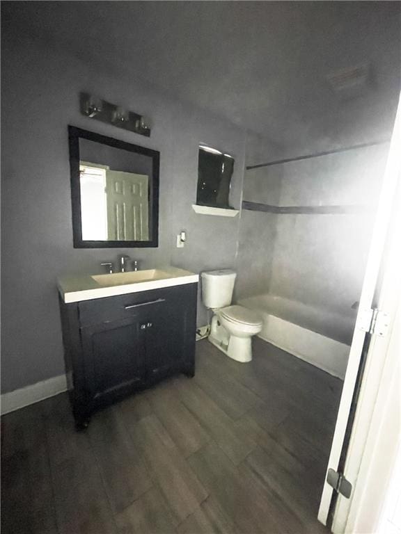 bathroom featuring wood-type flooring, toilet, and vanity