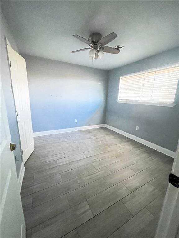 unfurnished room with ceiling fan