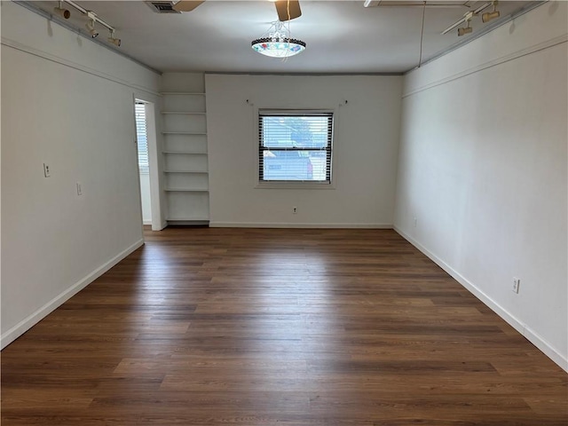 756 Mystic Ave, Gretna, LA 70056 - unfurnished room with baseboards, track lighting, built in features, and dark wood-style floors