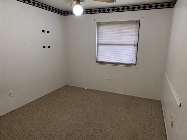 empty room with ceiling fan and carpet floors