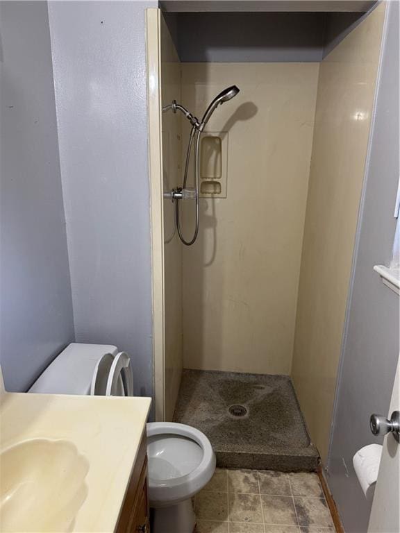 bathroom featuring toilet, walk in shower, and vanity