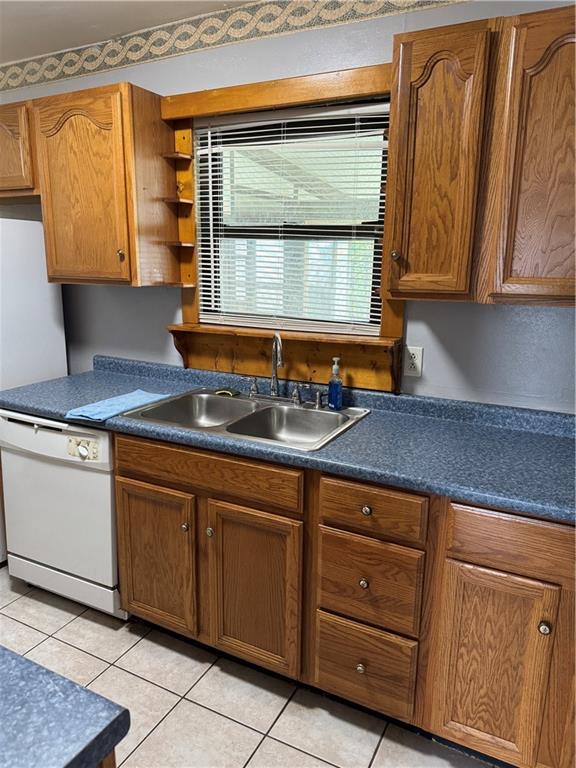 756 Mystic Ave, Gretna, LA 70056 - kitchen featuring dark countertops, white dishwasher, and a sink