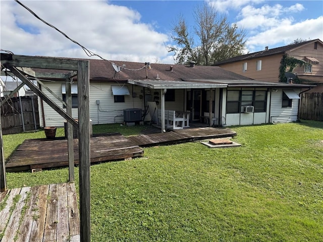 rear view of property with a wooden deck, a pergola, a yard, and central AC unit