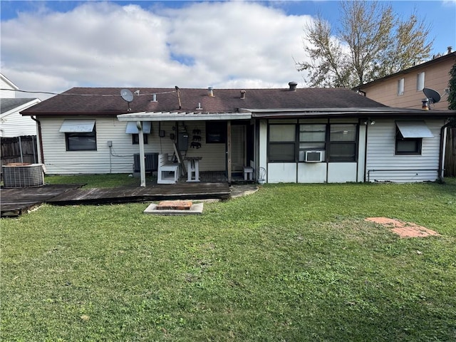 back of house with a lawn and a deck