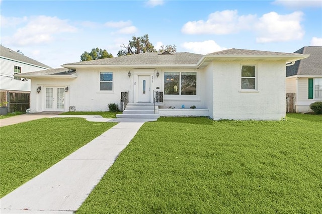 view of front of house featuring a front yard and french doors