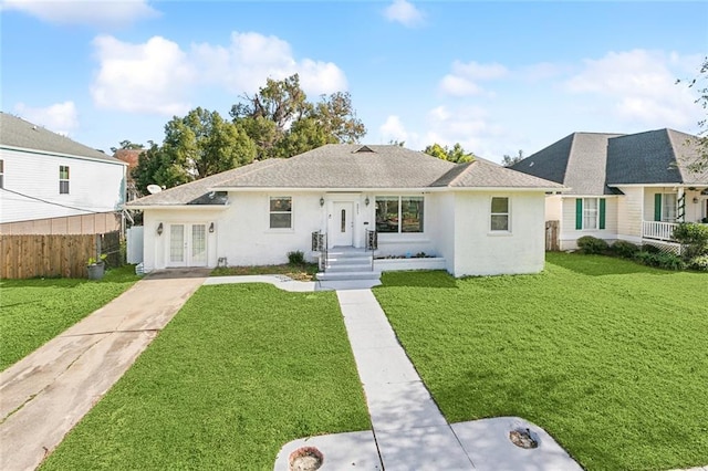 view of front facade featuring a front yard and french doors