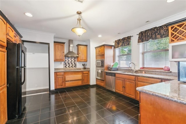 kitchen with black appliances, pendant lighting, ornamental molding, wall chimney exhaust hood, and sink