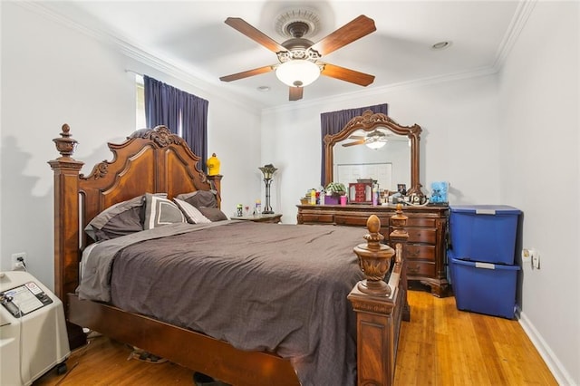 bedroom featuring ceiling fan, ornamental molding, and light hardwood / wood-style floors