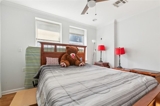 bedroom with ceiling fan, ornamental molding, and wood-type flooring