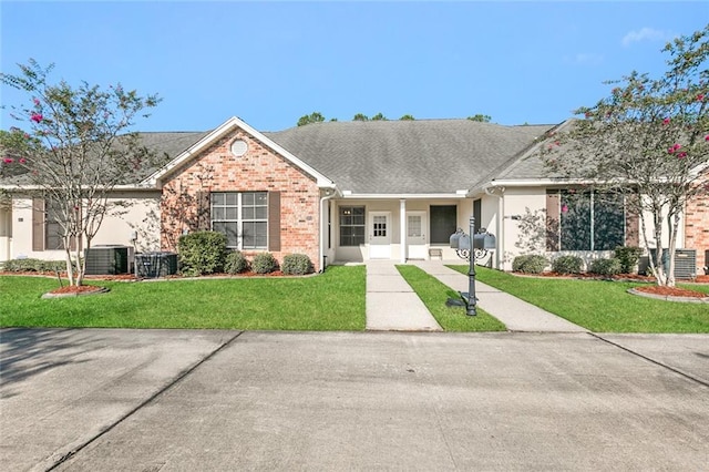 single story home featuring central AC unit and a front lawn