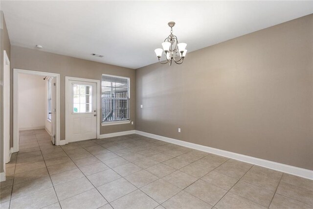 interior space featuring an inviting chandelier and light tile patterned floors