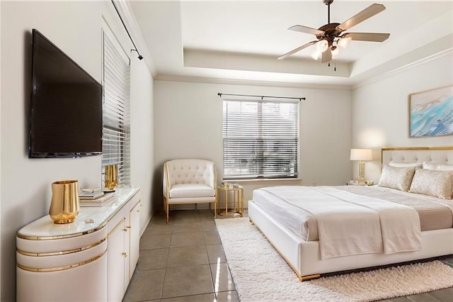 bedroom with ceiling fan, a raised ceiling, and dark tile patterned floors