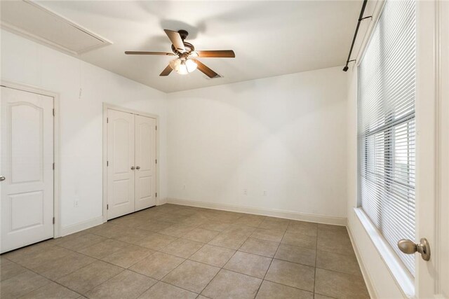 unfurnished bedroom featuring ceiling fan and light tile patterned floors