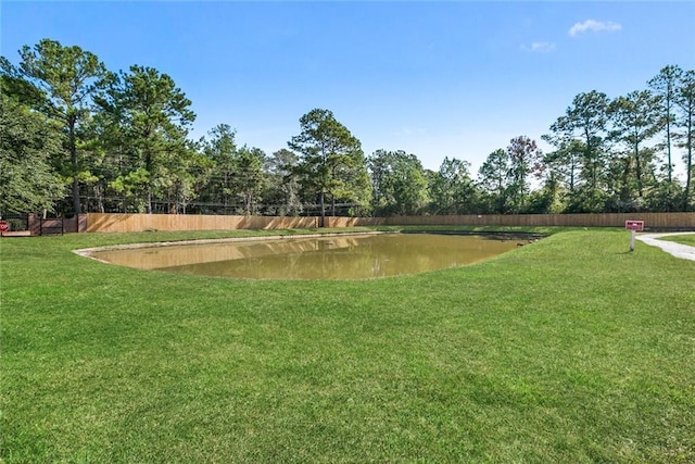 surrounding community with a lawn and a water view