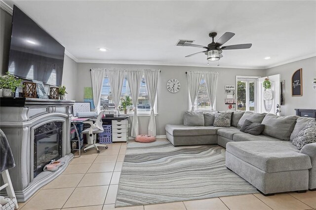 tiled living room featuring ceiling fan and crown molding