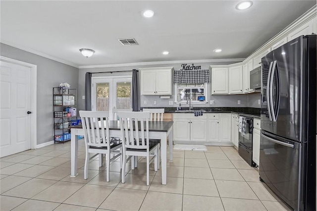 kitchen with ornamental molding, sink, white cabinets, and black appliances