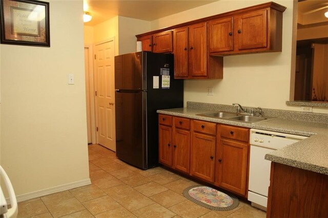 kitchen with sink, white dishwasher, and stainless steel refrigerator