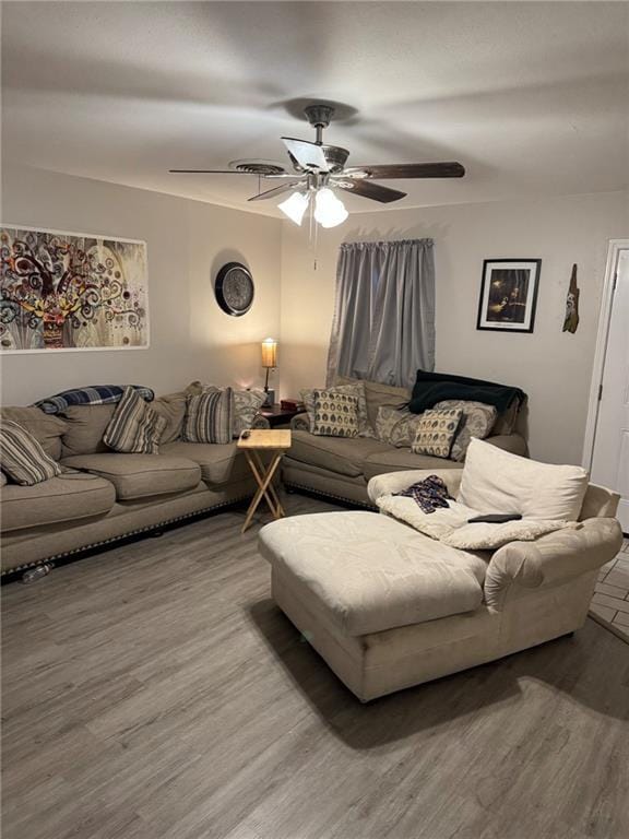 living room with ceiling fan and hardwood / wood-style flooring