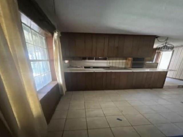 kitchen featuring kitchen peninsula and light tile patterned floors